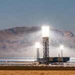 white and black tower near body of water during daytime