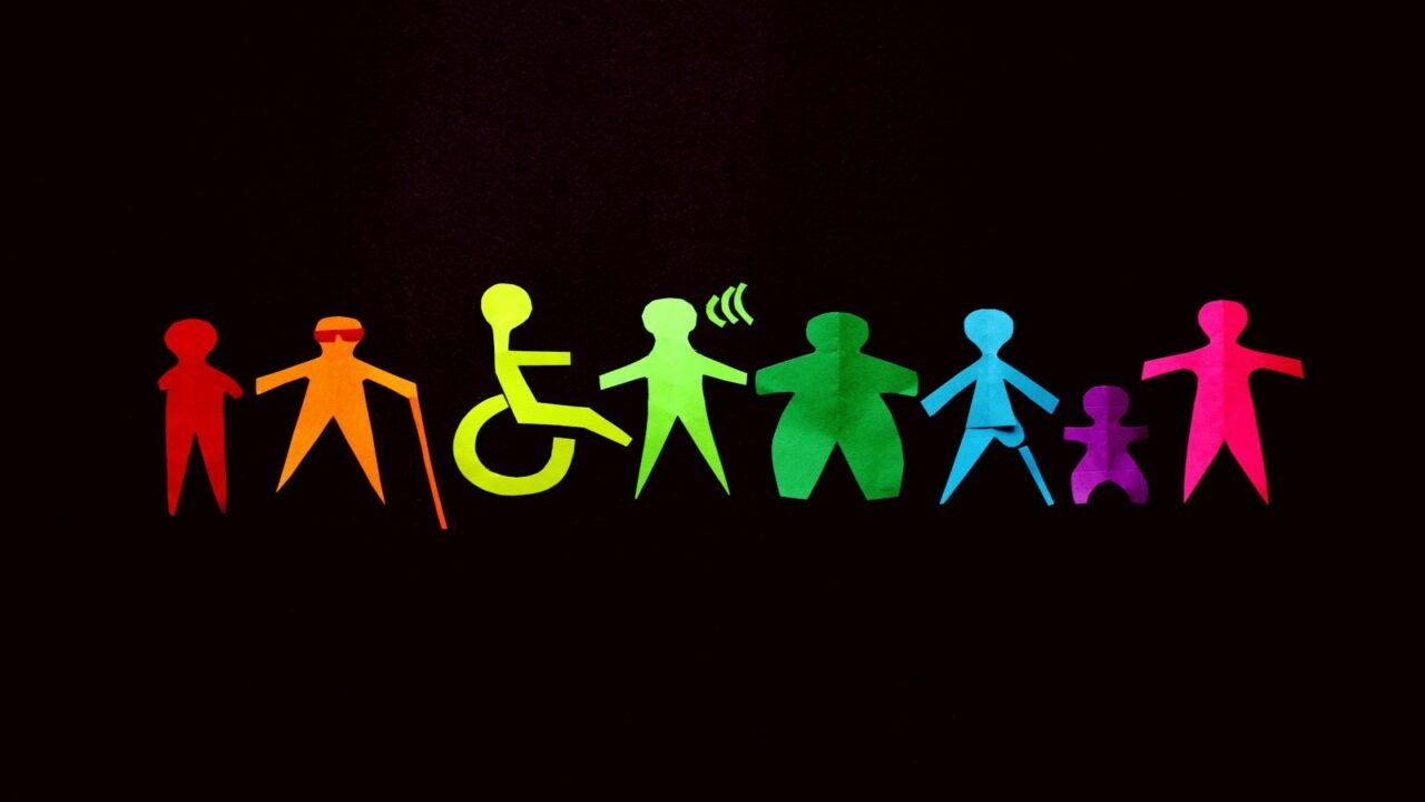 mapeo de actores, Vibrant paper cutouts of diverse figures on a black background promote inclusion and diversity.