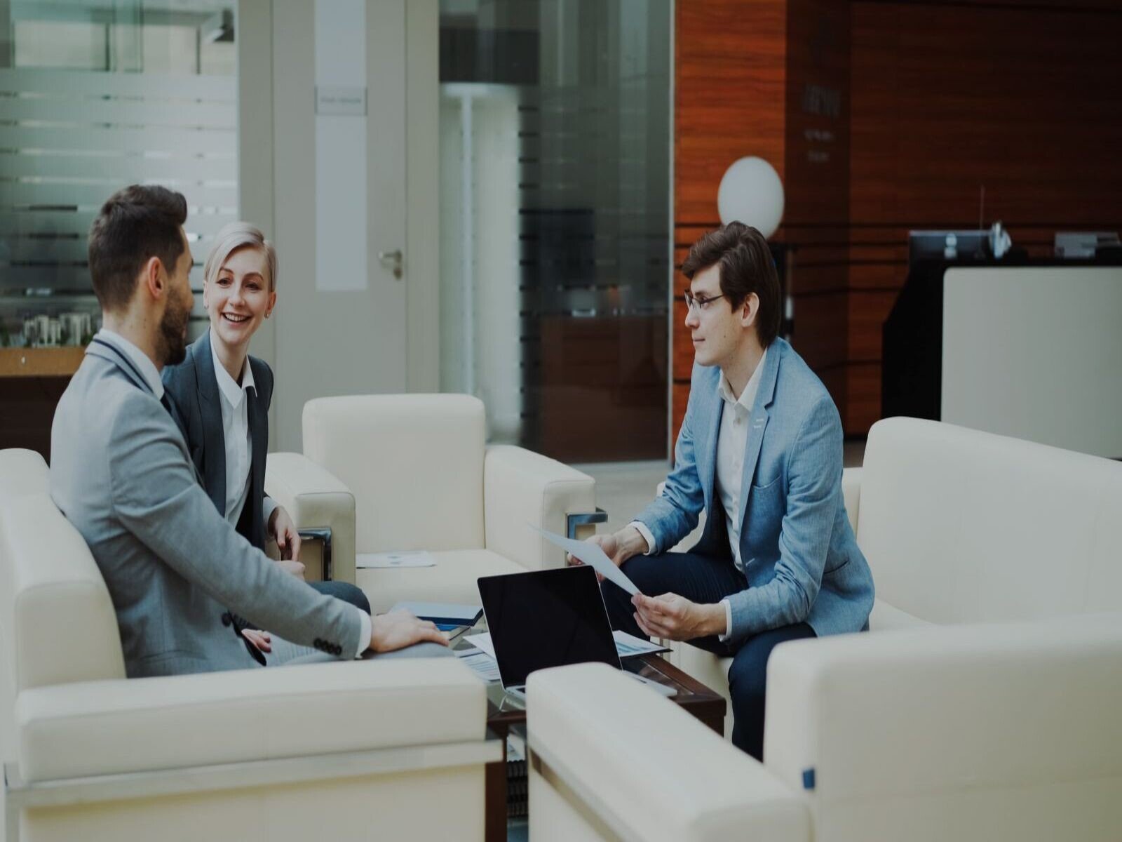 proceso de ventas B2B, Group of professionals having a productive business meeting in a modern office setting.
