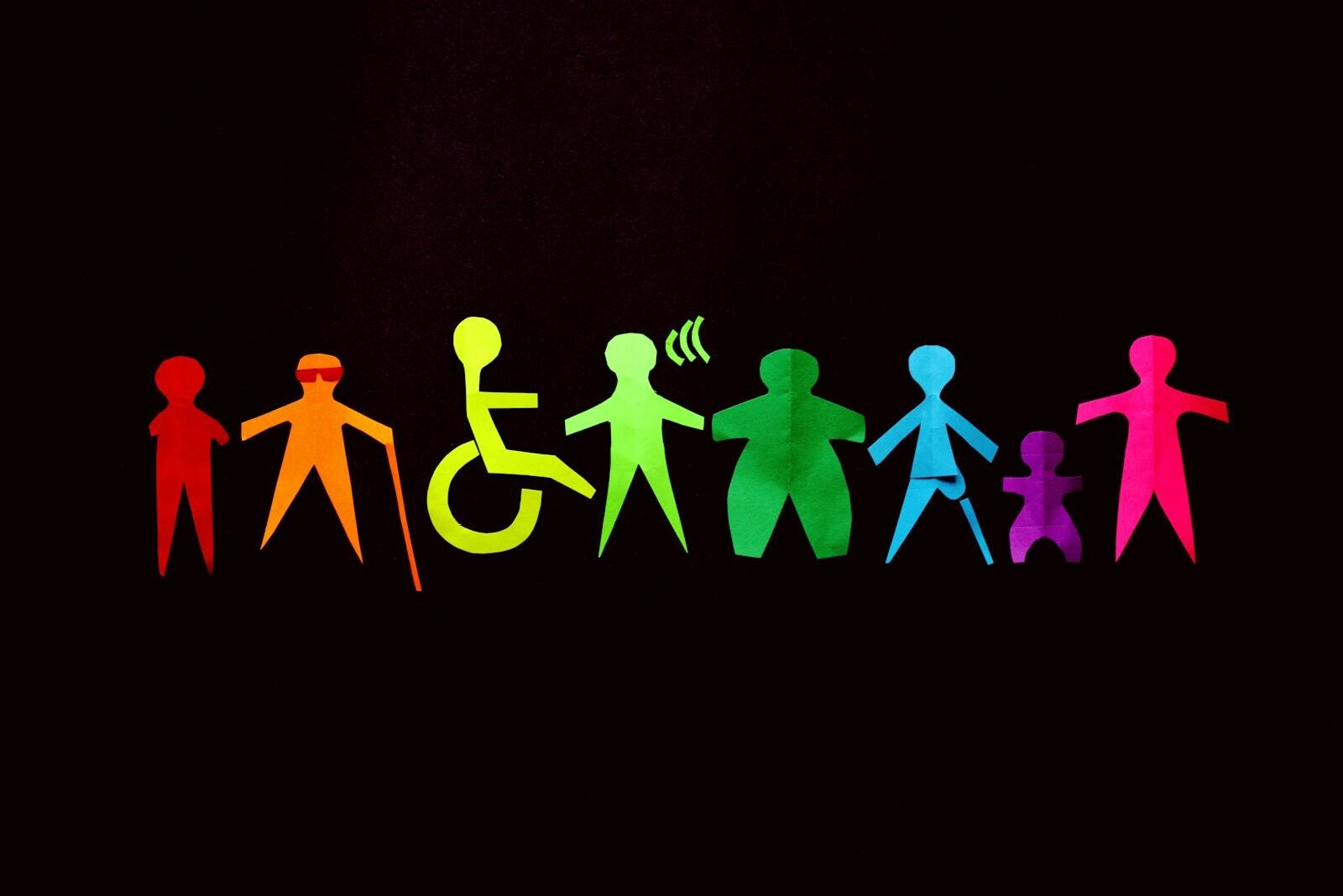 mapeo de actores, Vibrant paper cutouts of diverse figures on a black background promote inclusion and diversity.